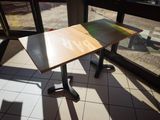 a table that has a sign on it in front of a window