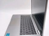 a silver laptop with a blue sticker on the keyboard