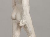 a white statue of a man standing on a table