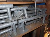 a bunch of pipes on a shelf in a room