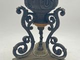 a blue vase that is on a stand on a white background