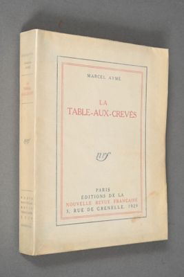 an old book sitting on top of a table on top of a table
