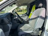 a white van with a yellow safety vest in the passenger seat