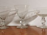 three empty wine glasses sitting on a wooden table