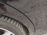 a close up of a car ' s tire on a gravel road