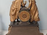 two figurines that are sitting next to each other on a table