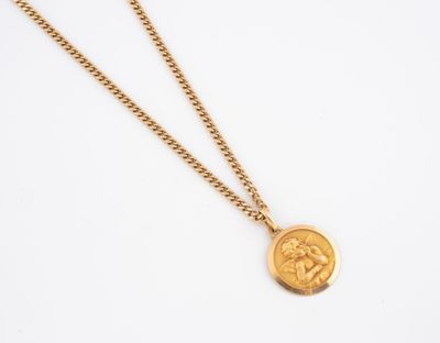 un collier composé d'une pièce d'or représentant un lion, suspendue à une chaîne