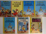 plusieurs livres pour enfants sont alignés sur une surface blanche
