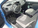 the interior of a small car with the door open and the seat up