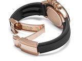 the rose gold and black watch is set on a black rubber band