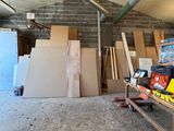 une pièce où il y a beaucoup de boîtes et de cartons sur le sol