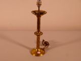 a gold colored lamp that is on a table