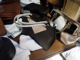 a table with a lot of purses and hats on it