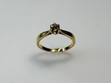 an image of a gold ring with a diamond on it