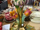 a vase with flowers on it sitting on a table