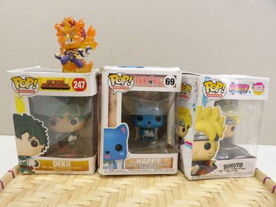 three different pop vinyl figures on a table