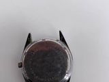 a close up of a watch on a white surface with a white background