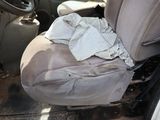 a dirty car seat with a dirty cloth on it