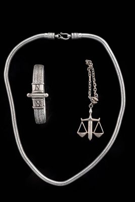 a silver necklace and bracelet set with a lady ' s scale and a lady ' s scale