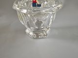 a small glass bowl with a small figurine in it