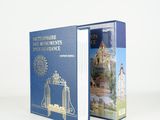 an open blue book with a picture of a castle on it
