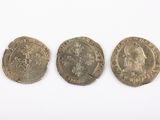 three silver coins, one of which has a crown and one of which has a crown on it
