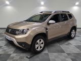 une photo d'une Dacia beige garée sur un sol à damier