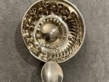 a silver spoon and a spoon rest on a table