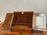 a small wooden box with a mirror on top of it