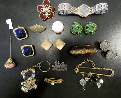 many different types of jewelry on a black surface