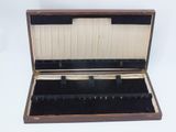 a wooden case with black velvet linings on the inside of it