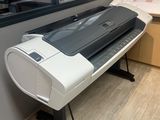 a large printer sitting on a stand in a room