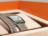 a box with a watch inside of it and a watch in it