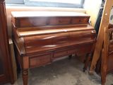 a piano and a bed in a room with a window