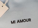 a close up of a blue shirt with a tag on it