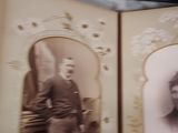 a person holding a book with an old photo inside of it
