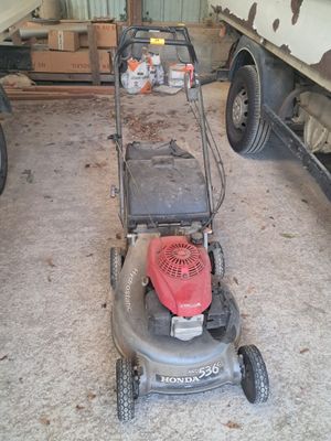 a lawn mower that is sitting in the garage