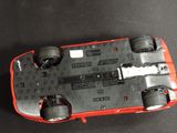 a toy car that is sitting on a black surface