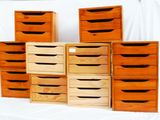 several wooden drawers are stacked on top of each other on a table