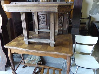several chairs and a table in a room with a clock on top of it