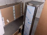 a refrigerator and a refrigerator freezer in a room full of boxes