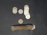 a pile of coins and a roll of coins on a table