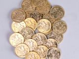 a pile of gold coins sitting on a white surface