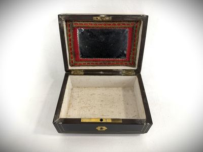 a small box with a mirror in it on a white surface