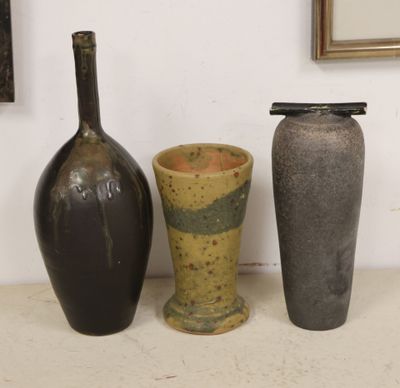 three vases sitting next to each other on a table