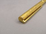 a close up of a gold colored pen on a table