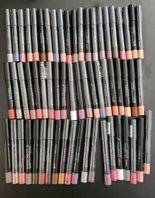 a pile of lip pencils sitting on top of a table