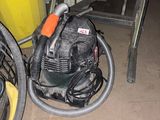 a small blower sitting next to a bike in a garage