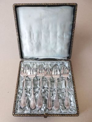 silverware in a silver case on a white surface