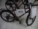 two bikes that are sitting on the floor with price tags on them